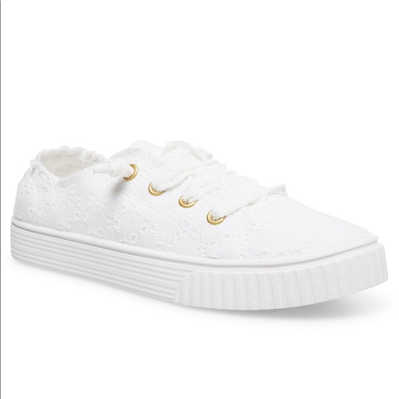 white eyelet tennis shoes